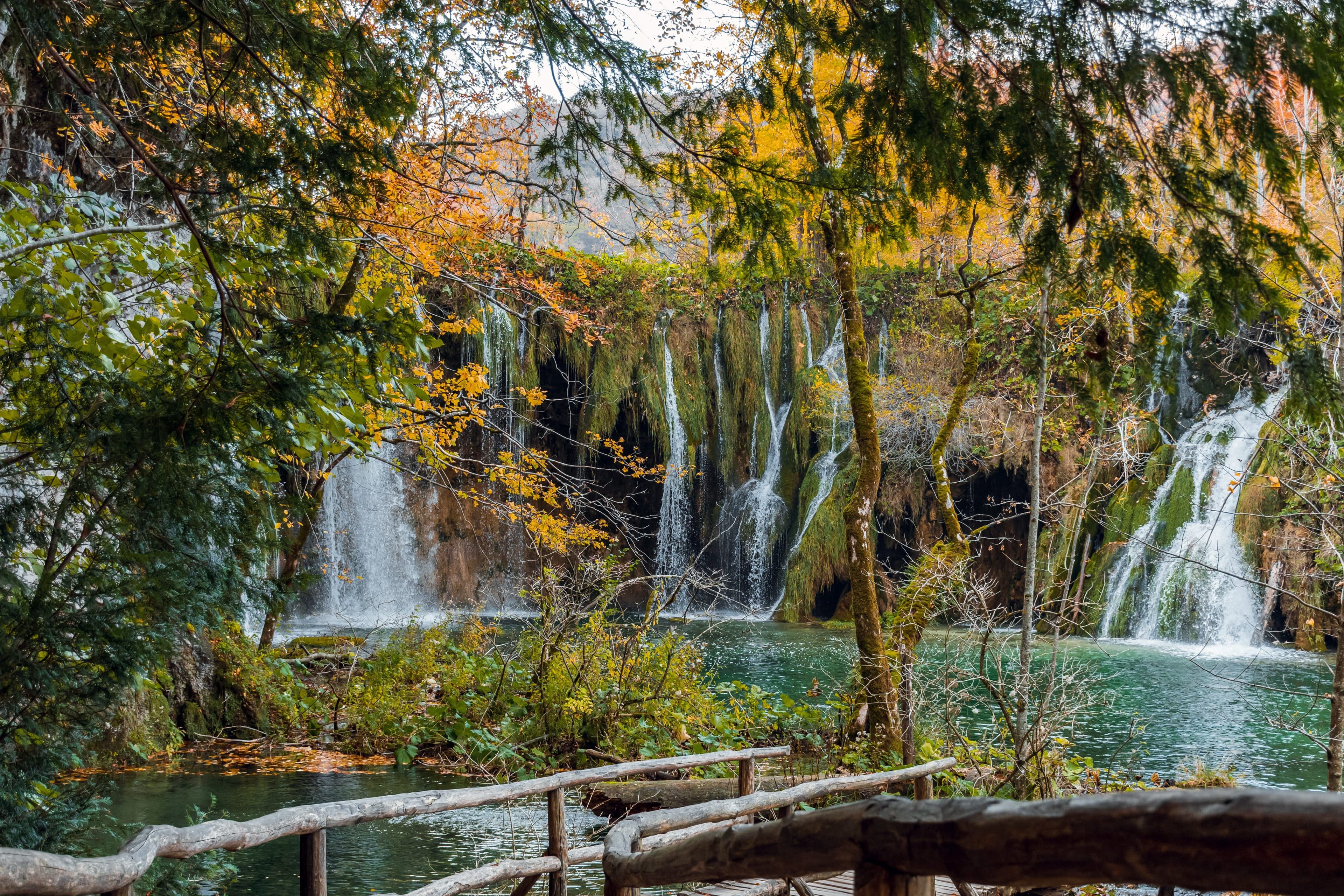 Wooden boardwalk beside waterfalls at Plitvice Lakes